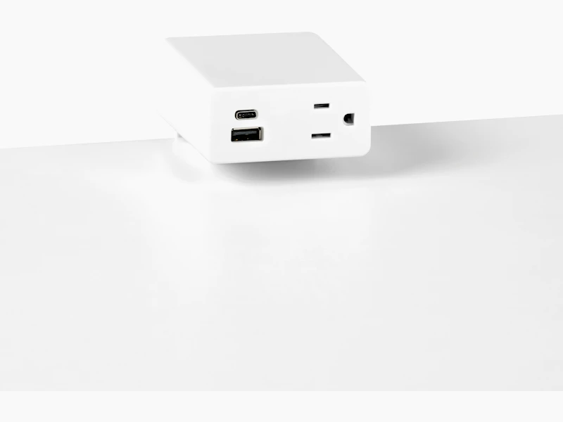 Close up image of a white surface mounted Logic Mini with two USB ports and one simplex receptacle.