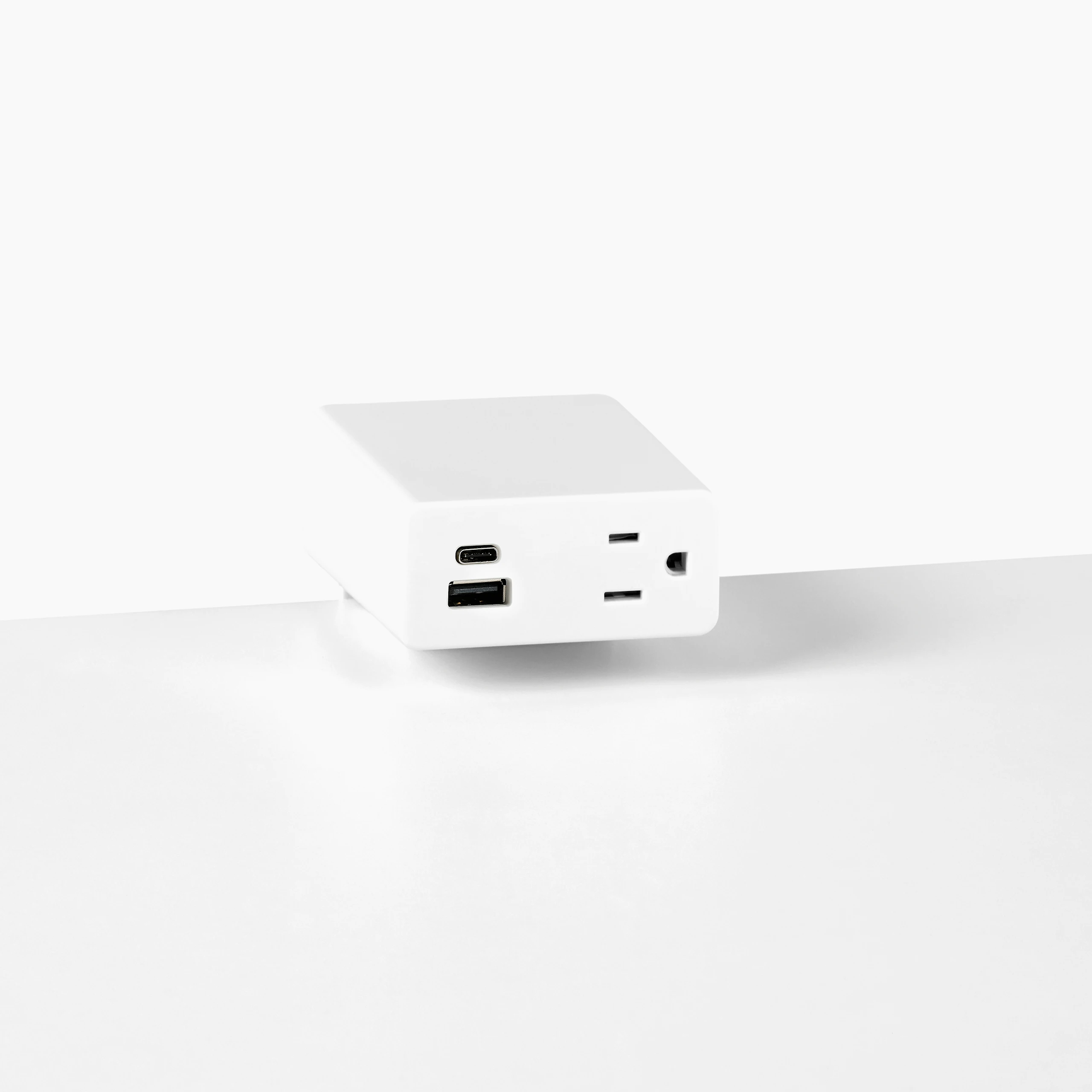 Close up image of a white surface mounted Logic Mini with two USB ports and one simplex receptacle.