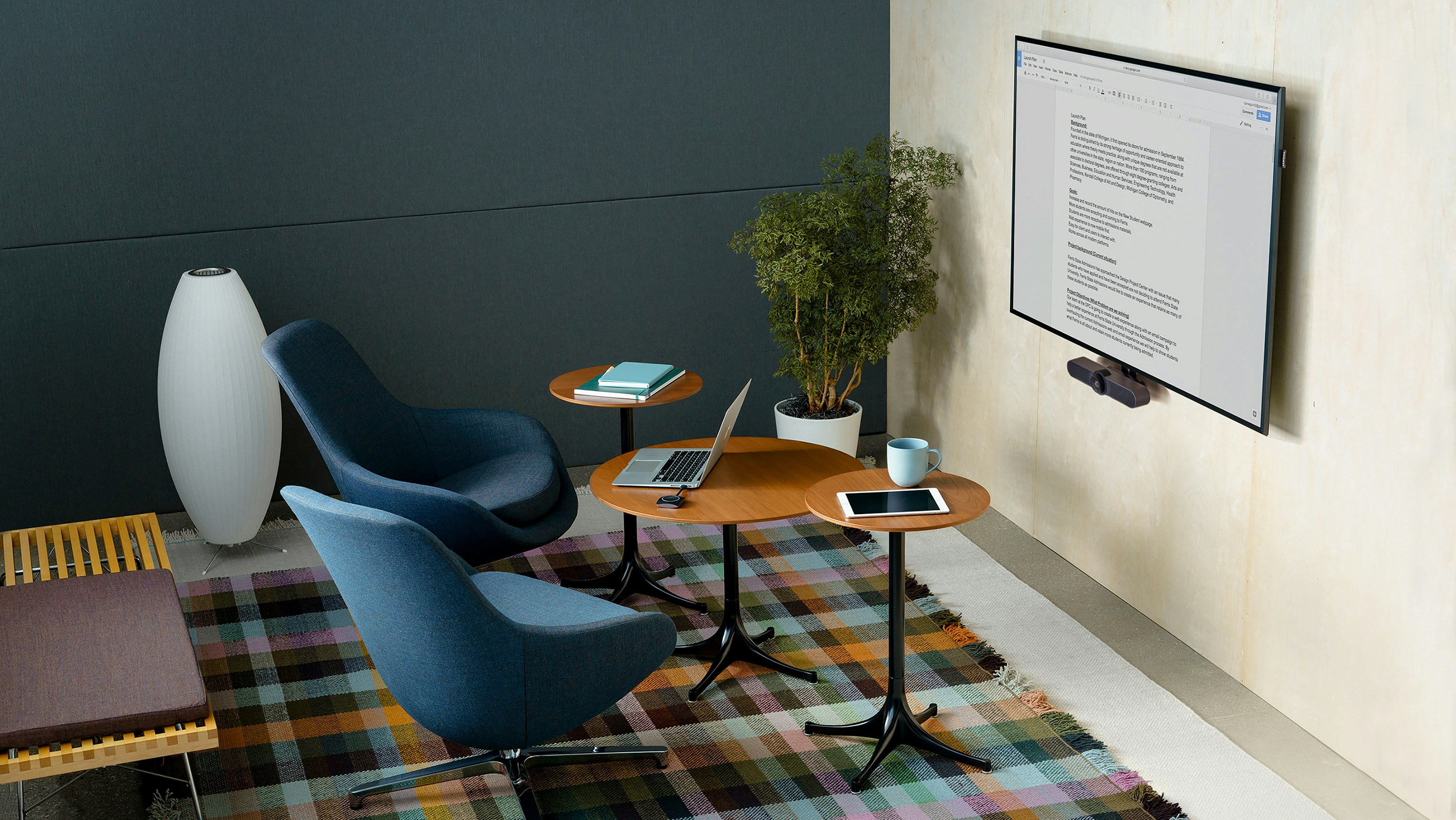 Small Meeting Space with upright lounge seating, occasional tables, and video conferencing.