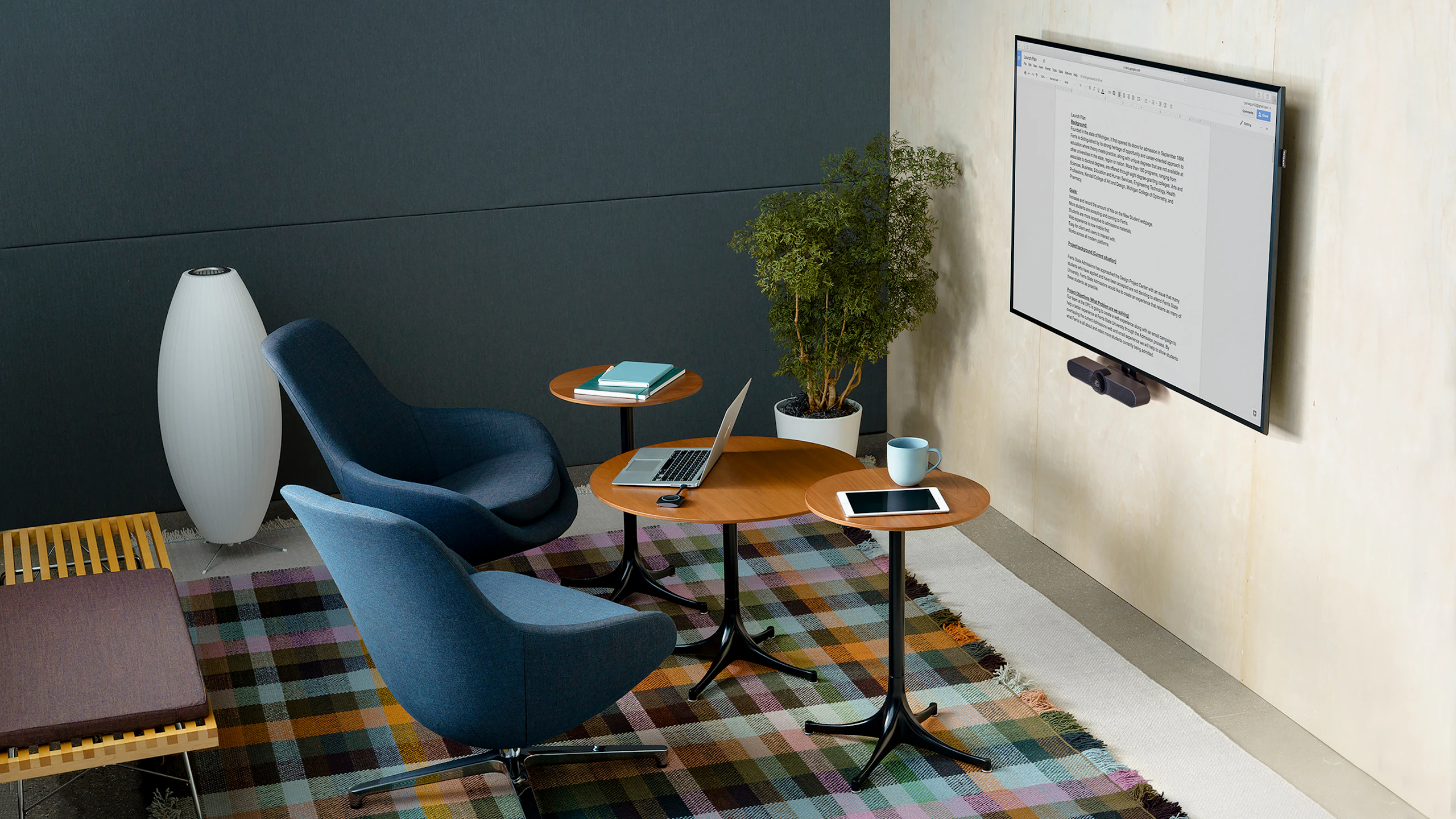 Small Meeting Space with upright lounge seating, occasional tables, and video conferencing.