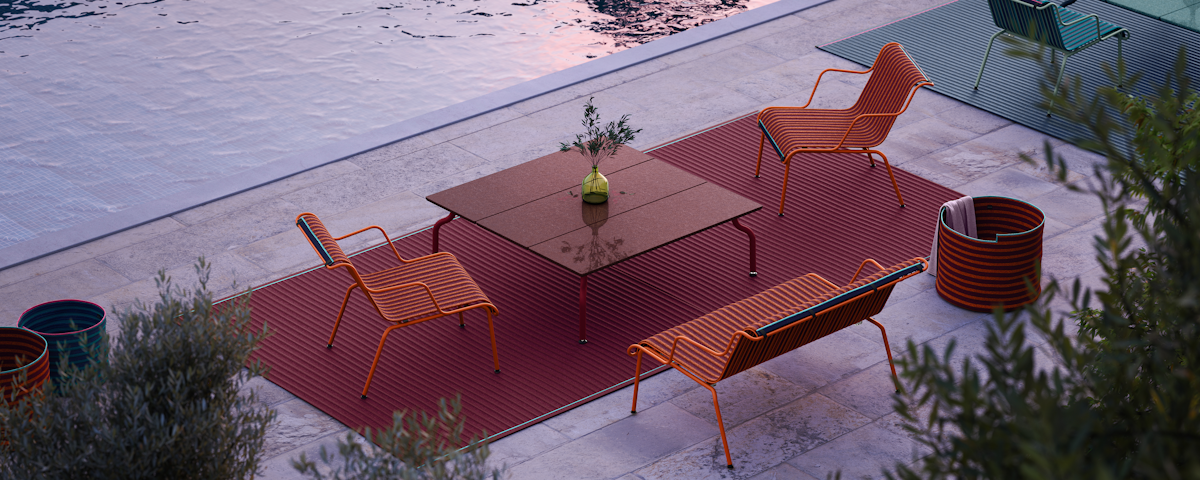 South Outdoor Coffee Table and South Outdoor Lounge Armchairs at a poolside setting
