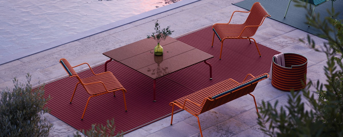 South Outdoor Lounge Armchairs and South Outdoor Lounge Bench at a poolside setting