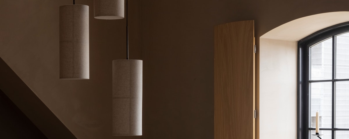 Three Hashira Pendant Lamps hanging in a living room