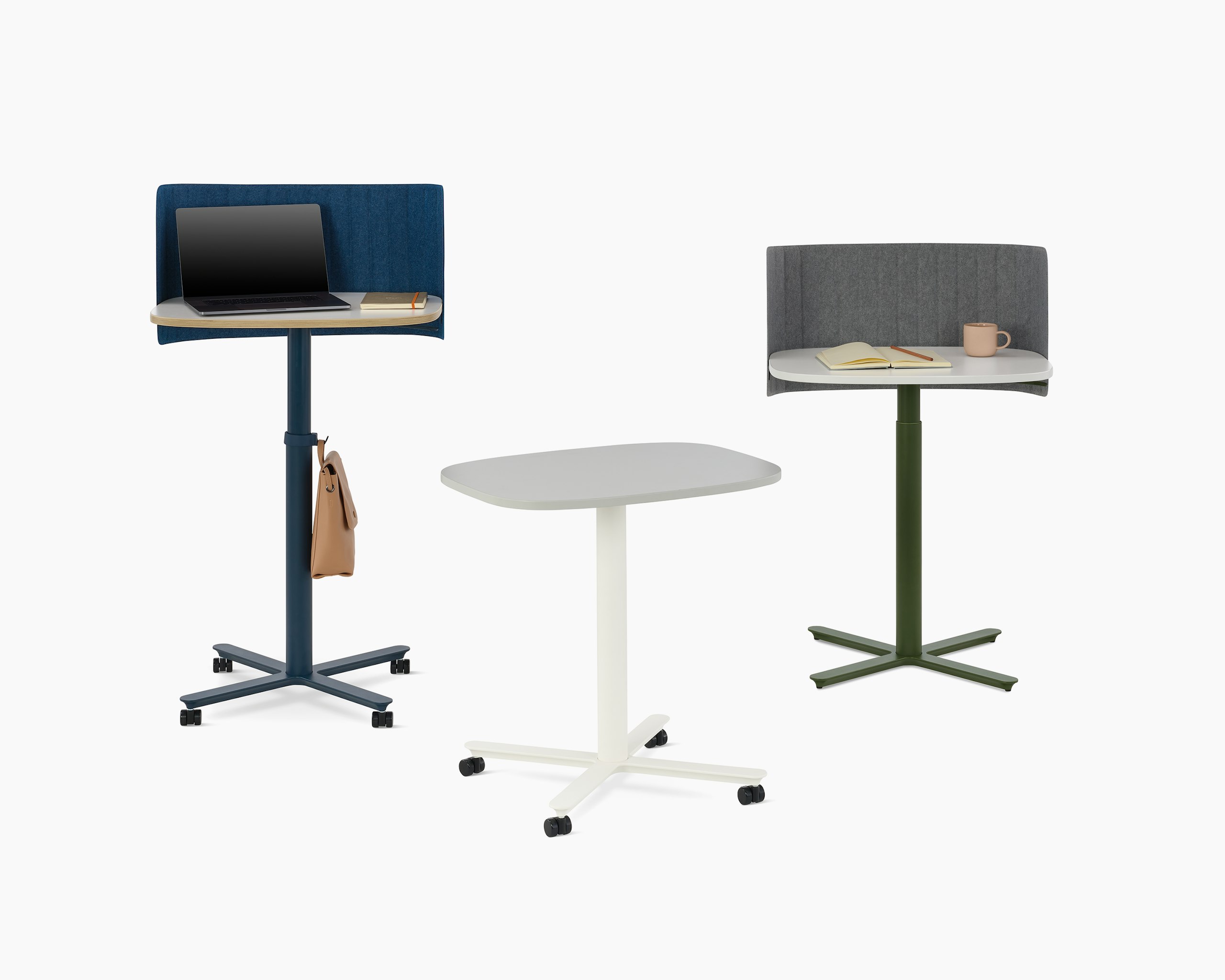 Multiple large Passport Work Tables shown with white and light grey tops and a variety of base colors and accessories.