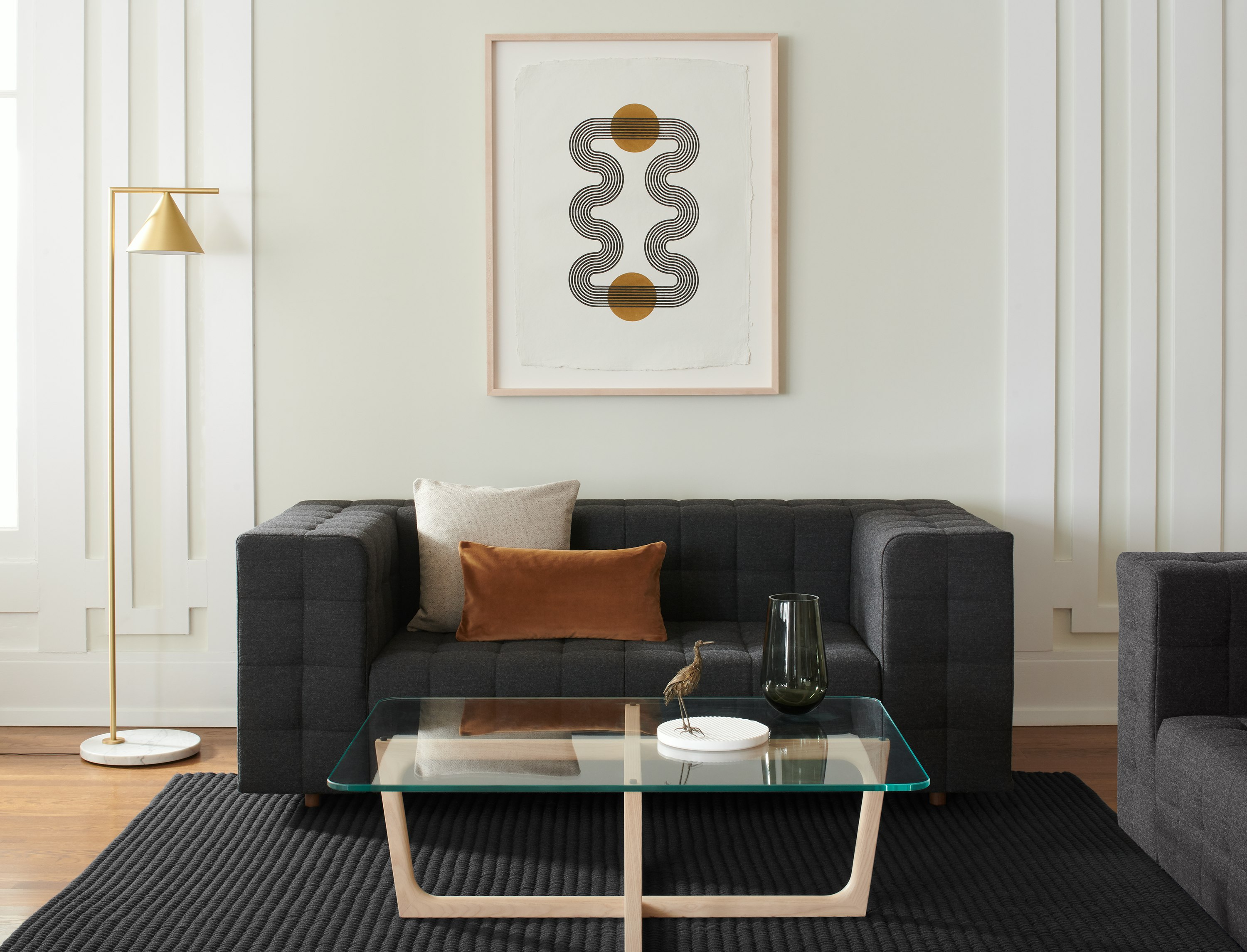 A lounge area featuring a Rapport Settee and Loophole Table.