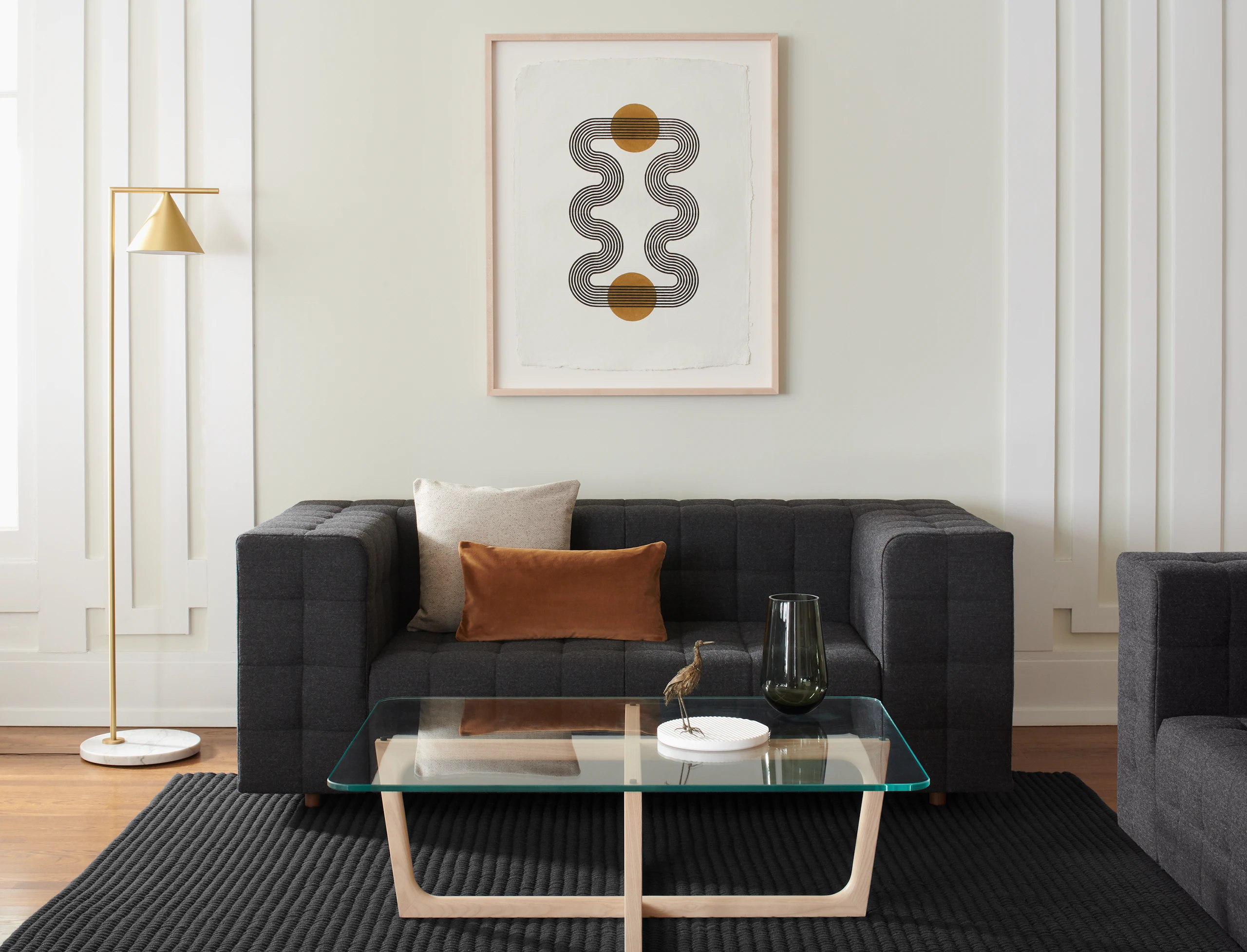 A lounge area featuring a Rapport Settee and Loophole Table.