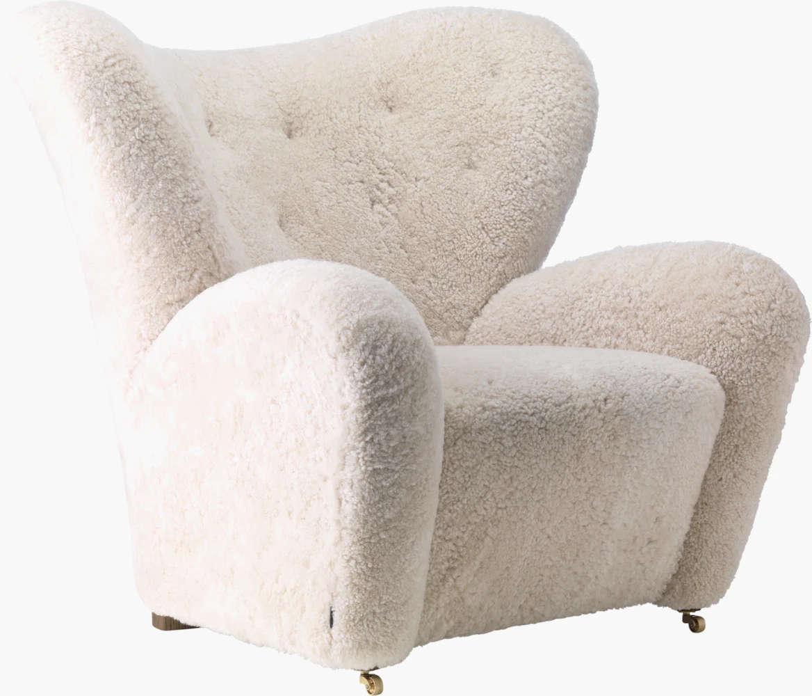 Close-up of a white boucle armchair on wheels with soft fluffy texture.