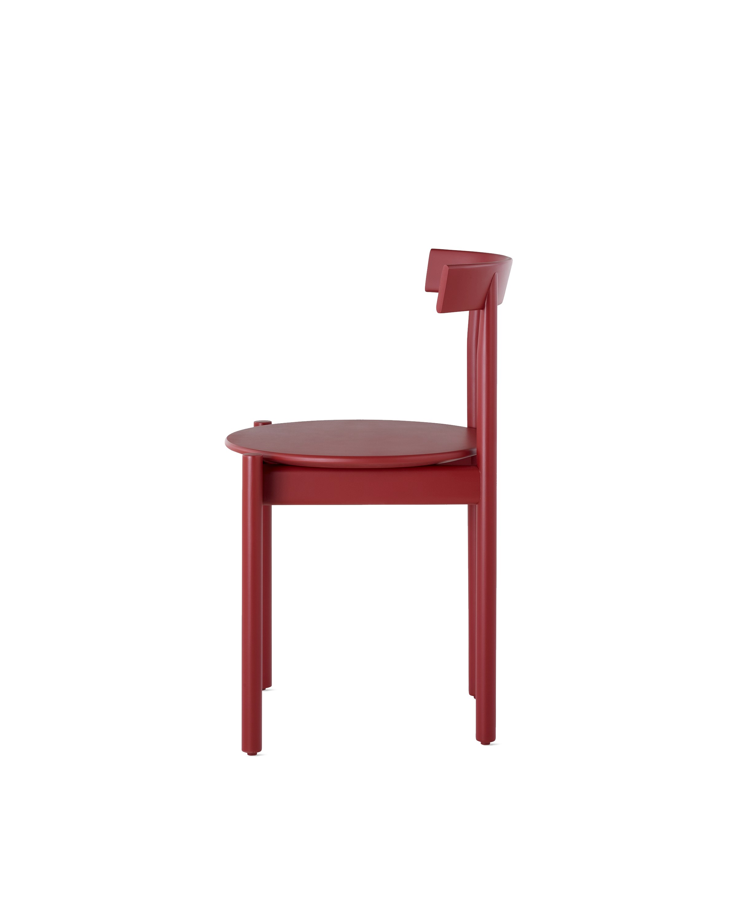 Profile view of a red Comma Chair.