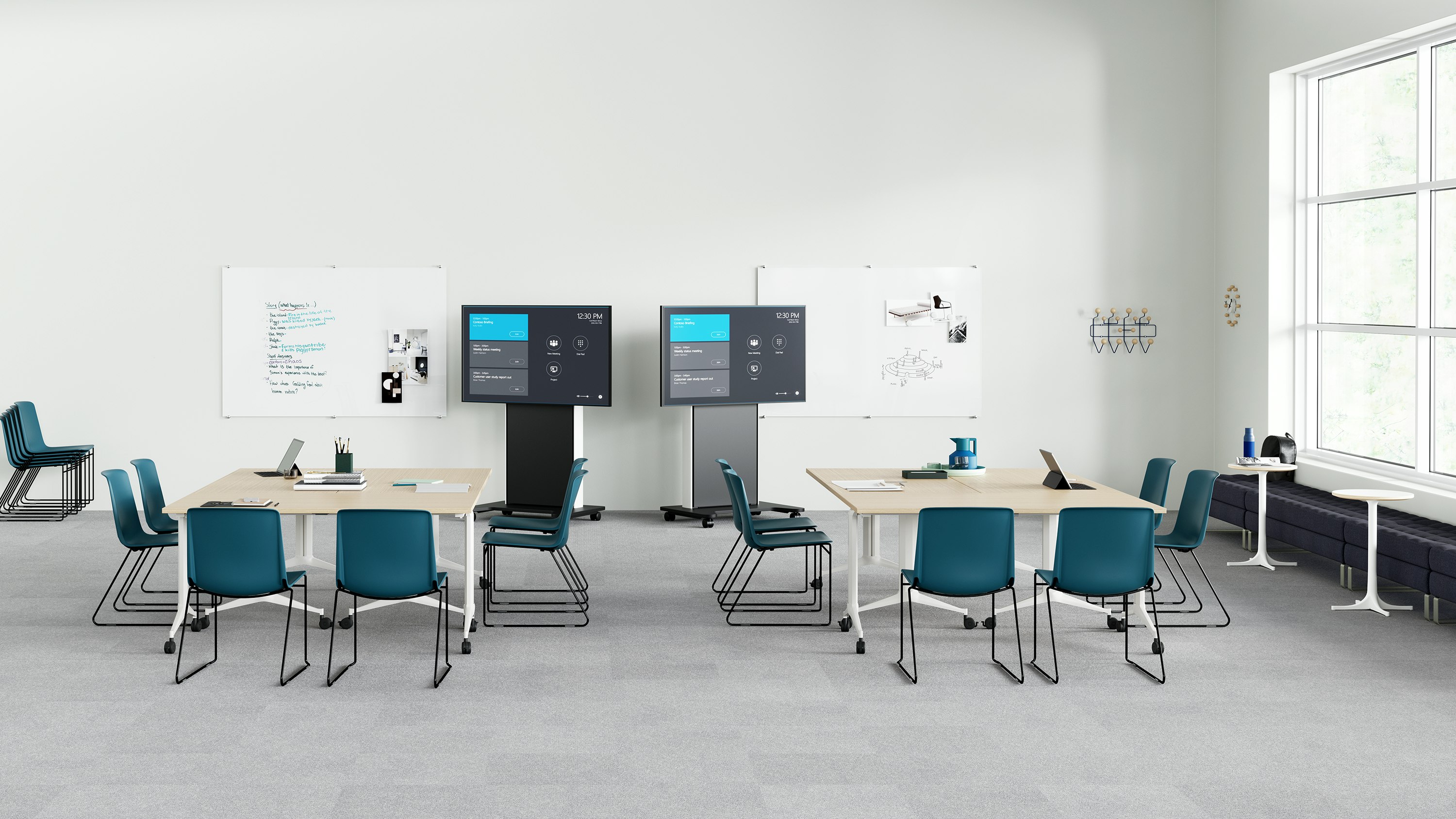 Peacock Pronta Stacking Chairs in a corporate learning space with flip-top tables, AVVC One media displays, and glass white boards.