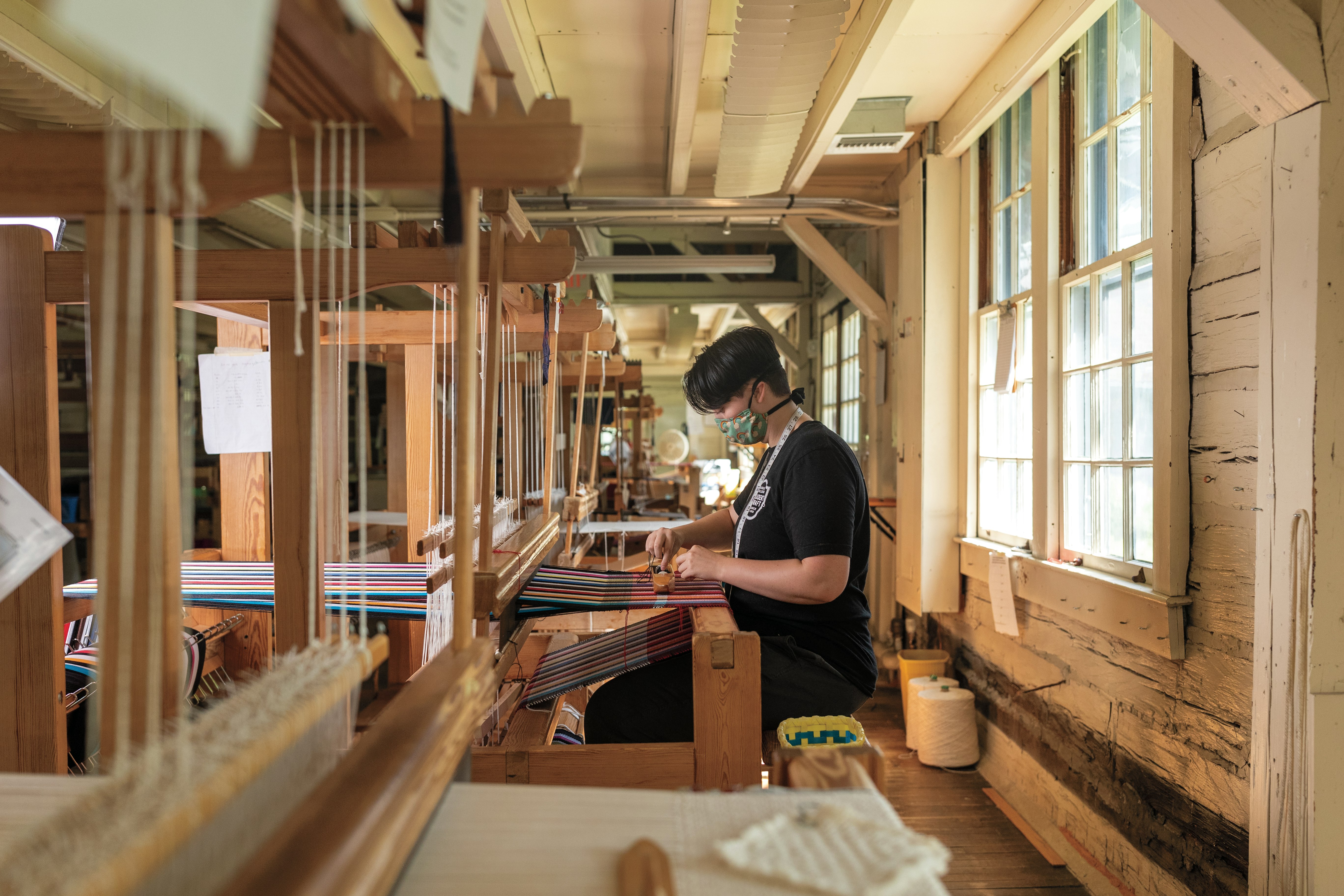 Man weaving Pixel Runner in loom
