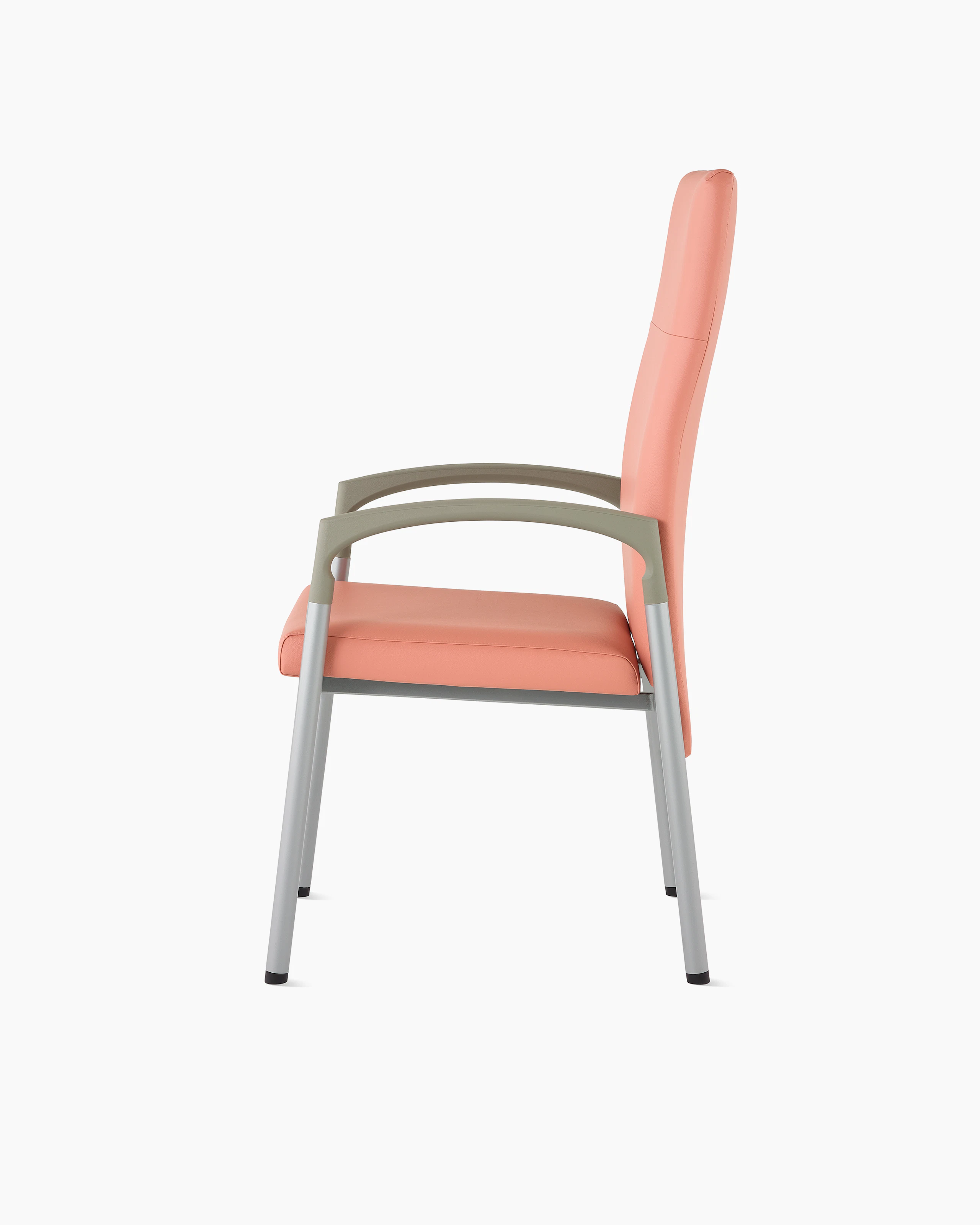 Side view of a high-back Valor patient chair in a salmon upholstery and silver frame with pewter armcaps.