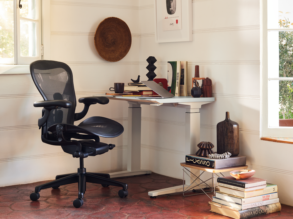 Renew Sit-to-Stand Desk,  Aeron Chair,  Nelson Face Print,  and Eames Wire Base Low Table