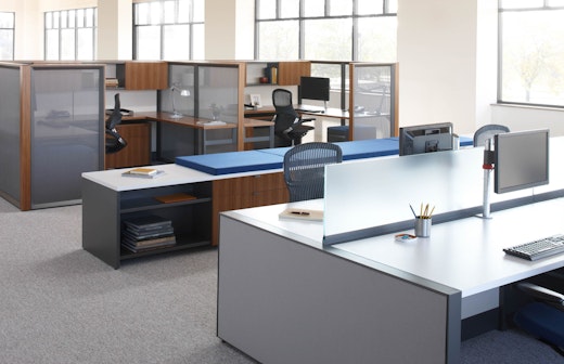 Dividends Skyline worksurface height panels used in a benching application with double depth credenzas