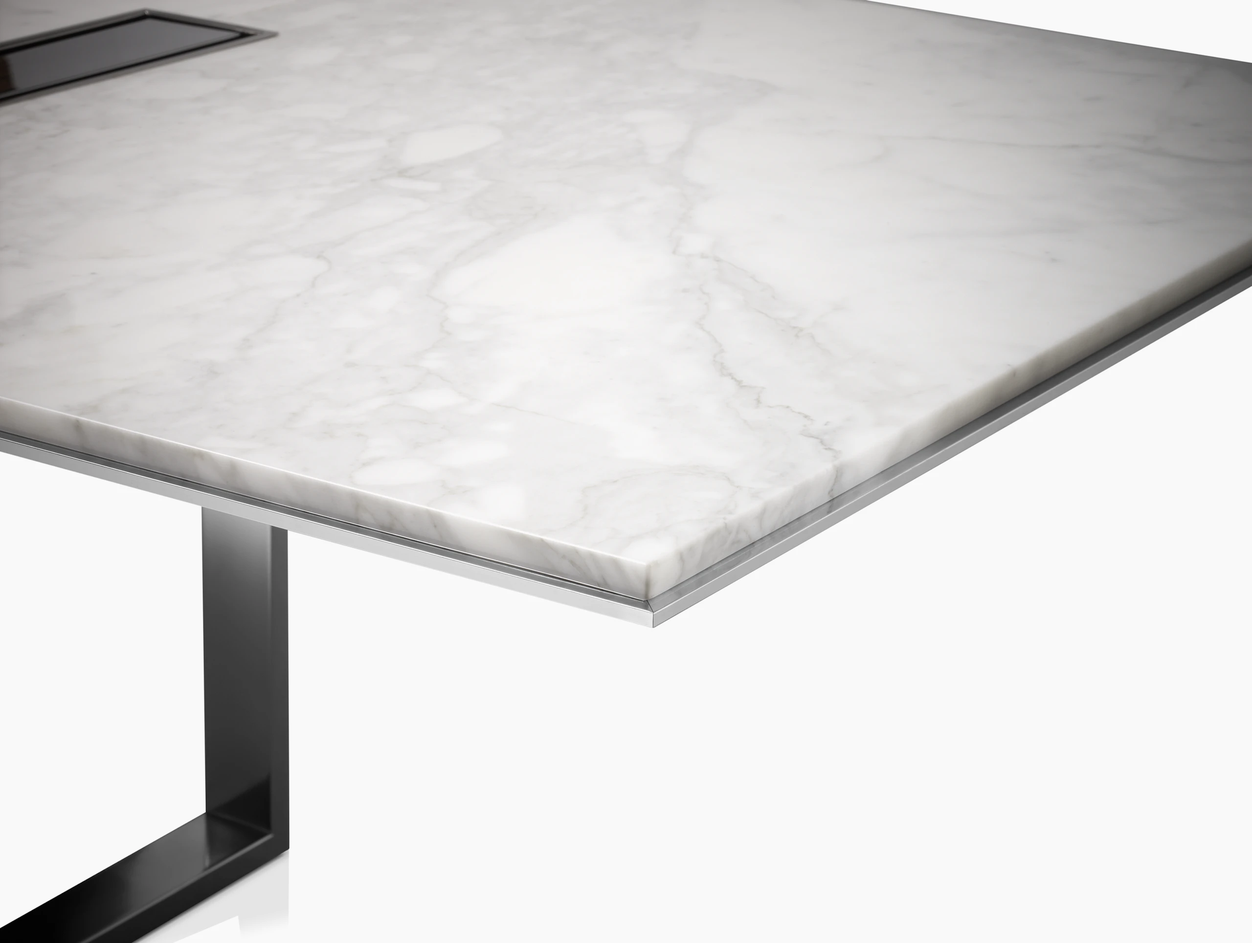 Highline Conference Table with White Carrara top, Polished Chrome base, Metal Edge detail, tabletop power, corner detail view.