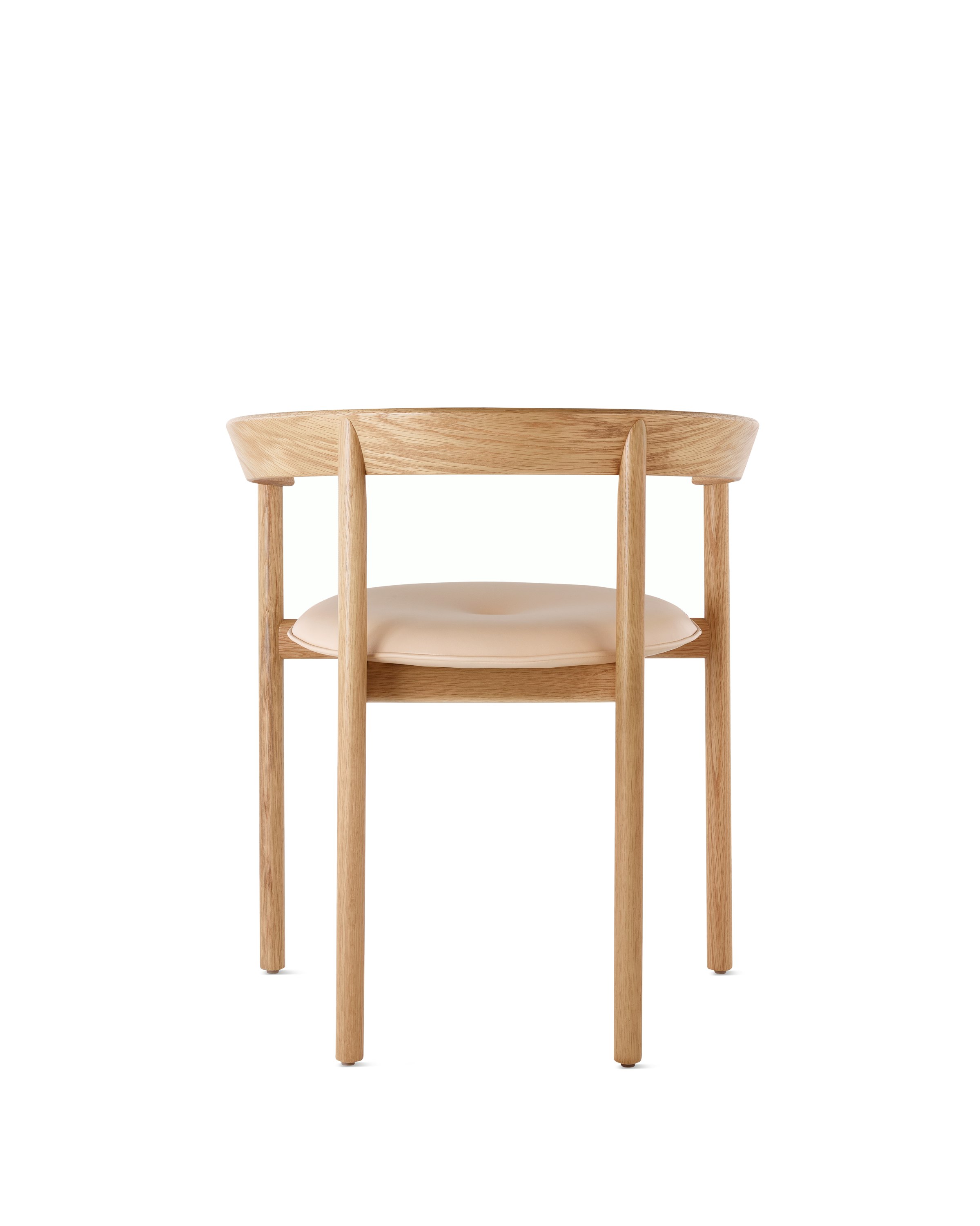 An oak Comma Chair with arms and a seat pad, viewed from the back.