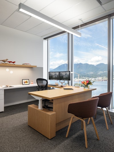 A private office at Blakes law firm - furnished with Herman Miller Aeron chairs and HAY About A chairs - overlooking mountains in Vancouver