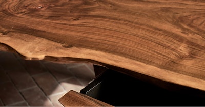 A wood table on top of a brick floor