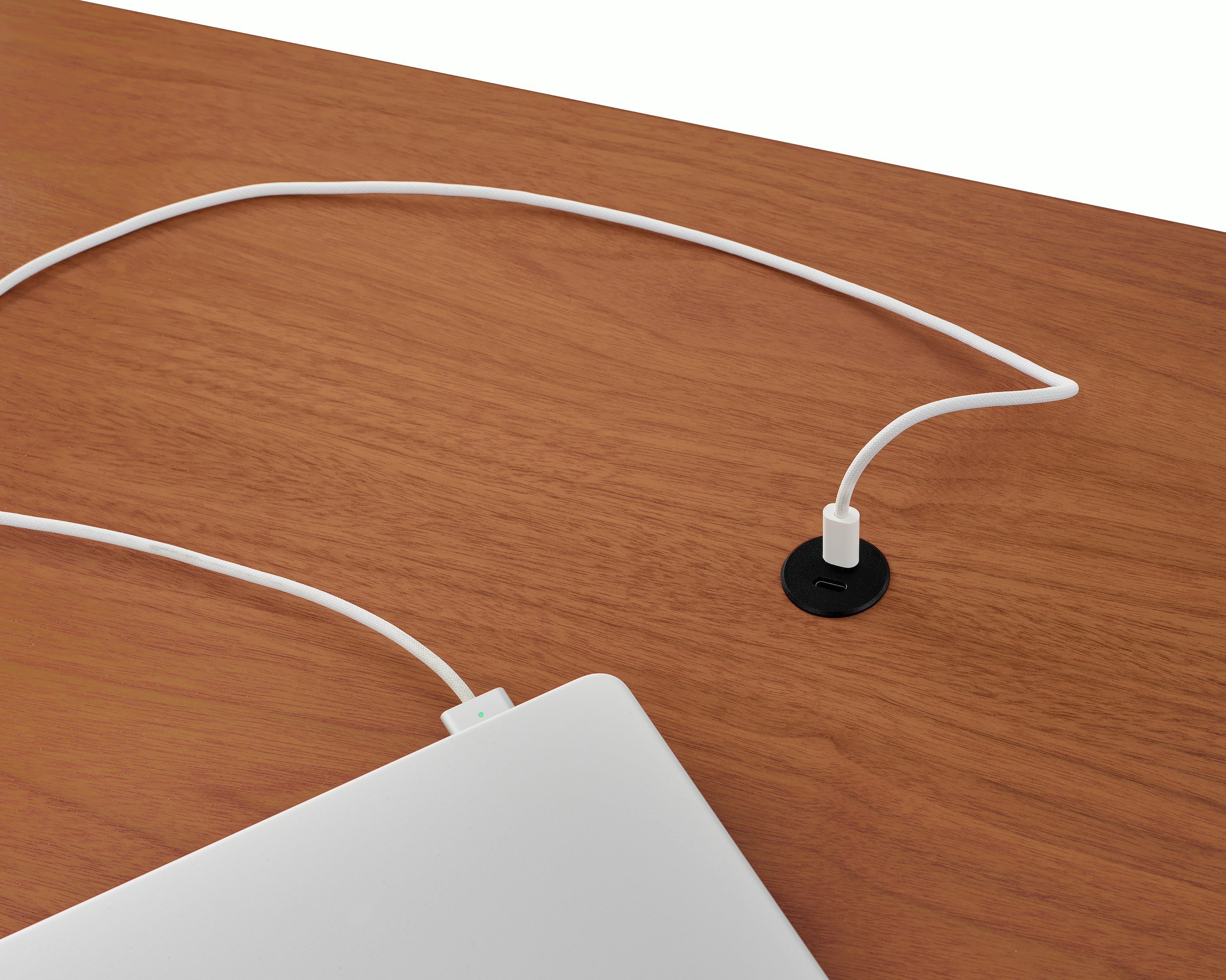 Surface-integrated dual port USB-C power solution charging a laptop shown in black.