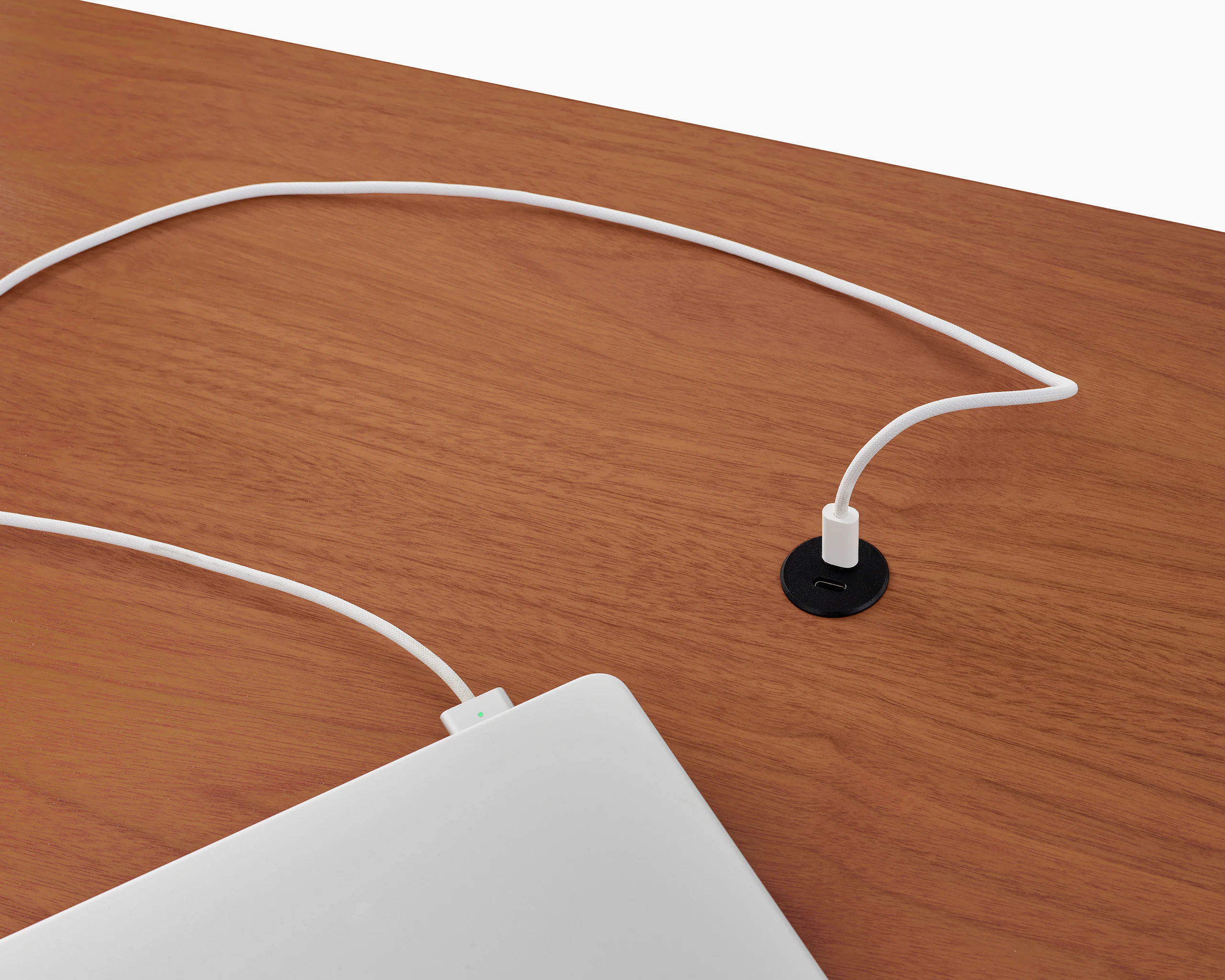 Surface-integrated dual port USB-C power solution charging a laptop shown in black.