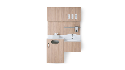 Front view of Compass System casework wall unit in a medium elm wood laminate finish with integrated waste receptacle, white solid surface sink, and upper storage for gloves.