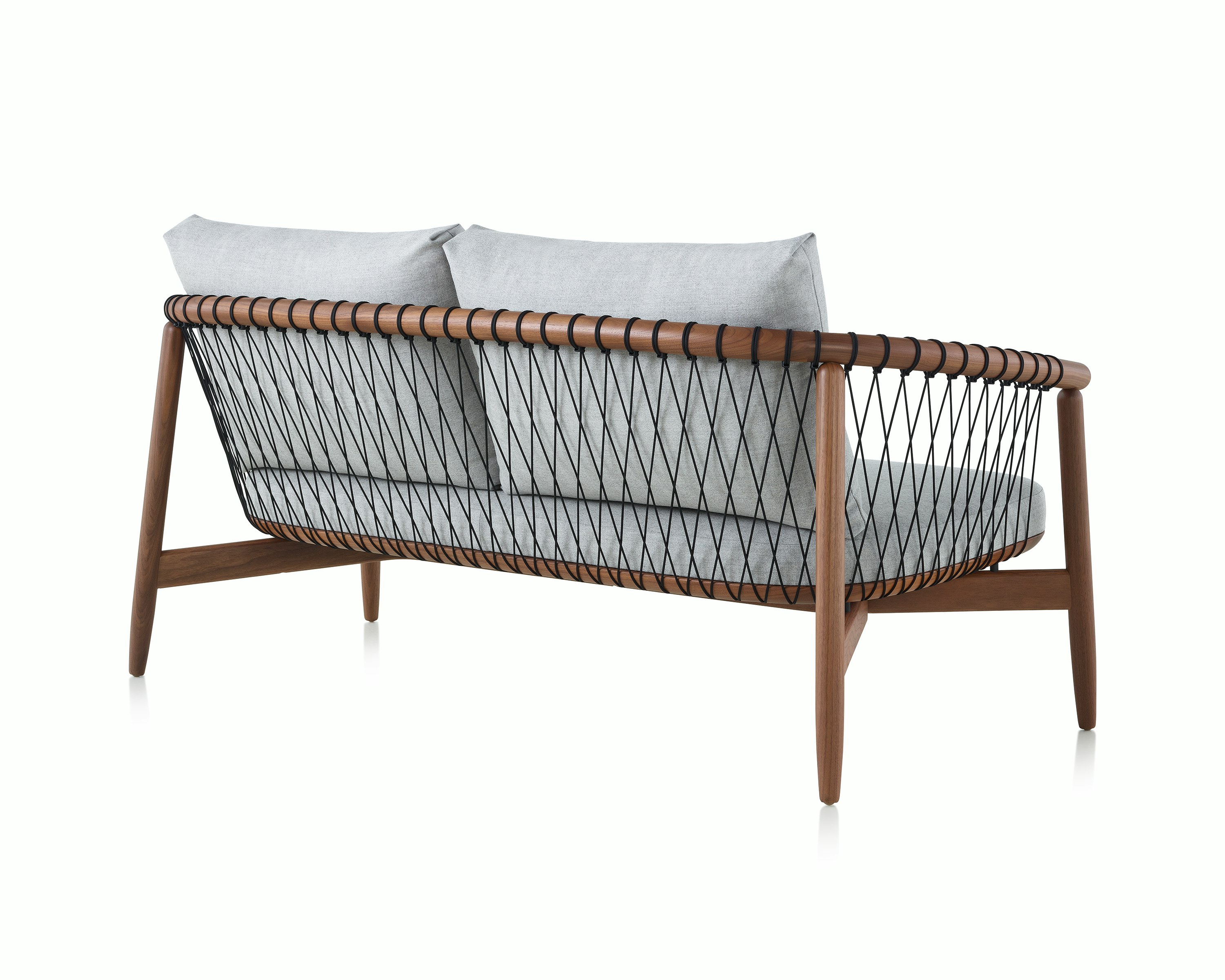 A Crosshatch Settee with a walnut frame, black cords, and a light neutral fabric. Viewed from the back.