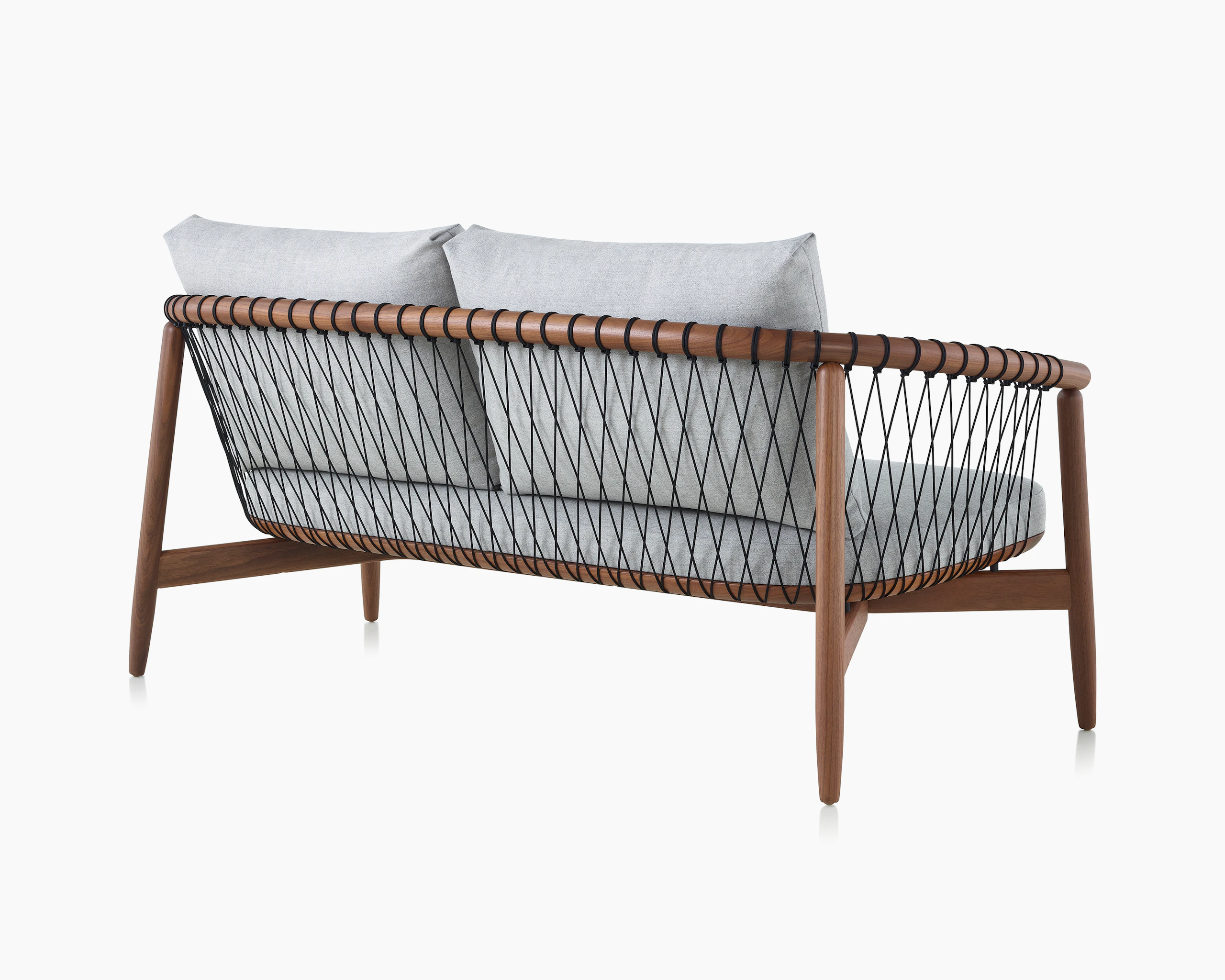 A Crosshatch Settee with a walnut frame, black cords, and a light neutral fabric. Viewed from the back.