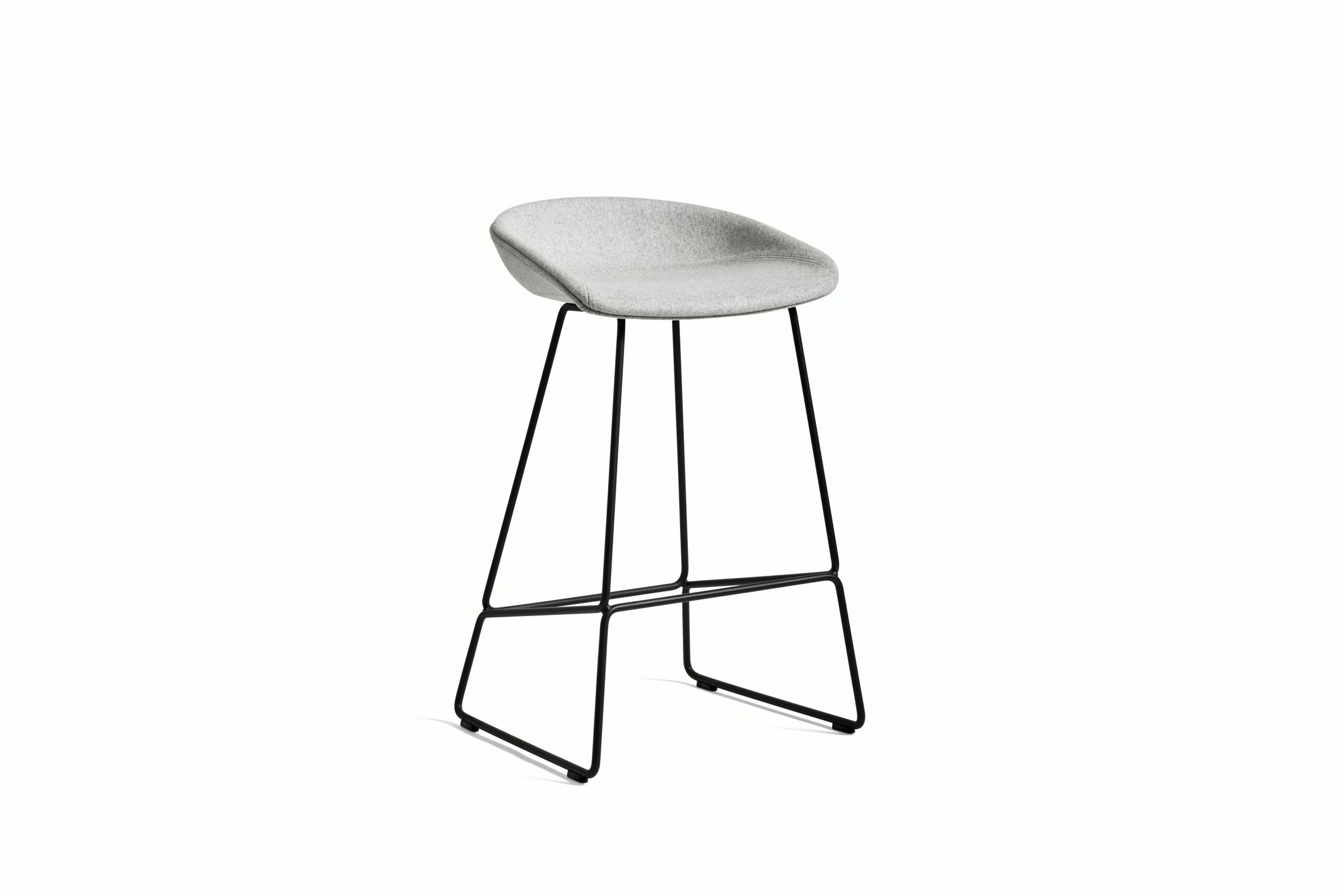Grey upholstered About A Stool with metal base, viewed at an angle.