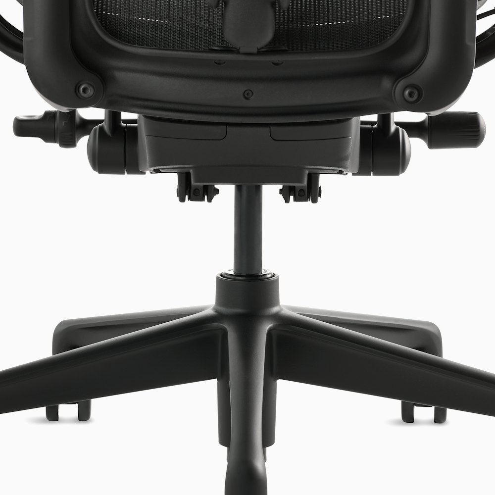 Black matte Aeron Chair on a white background, detailed view of the 5-star base and chair bottom.