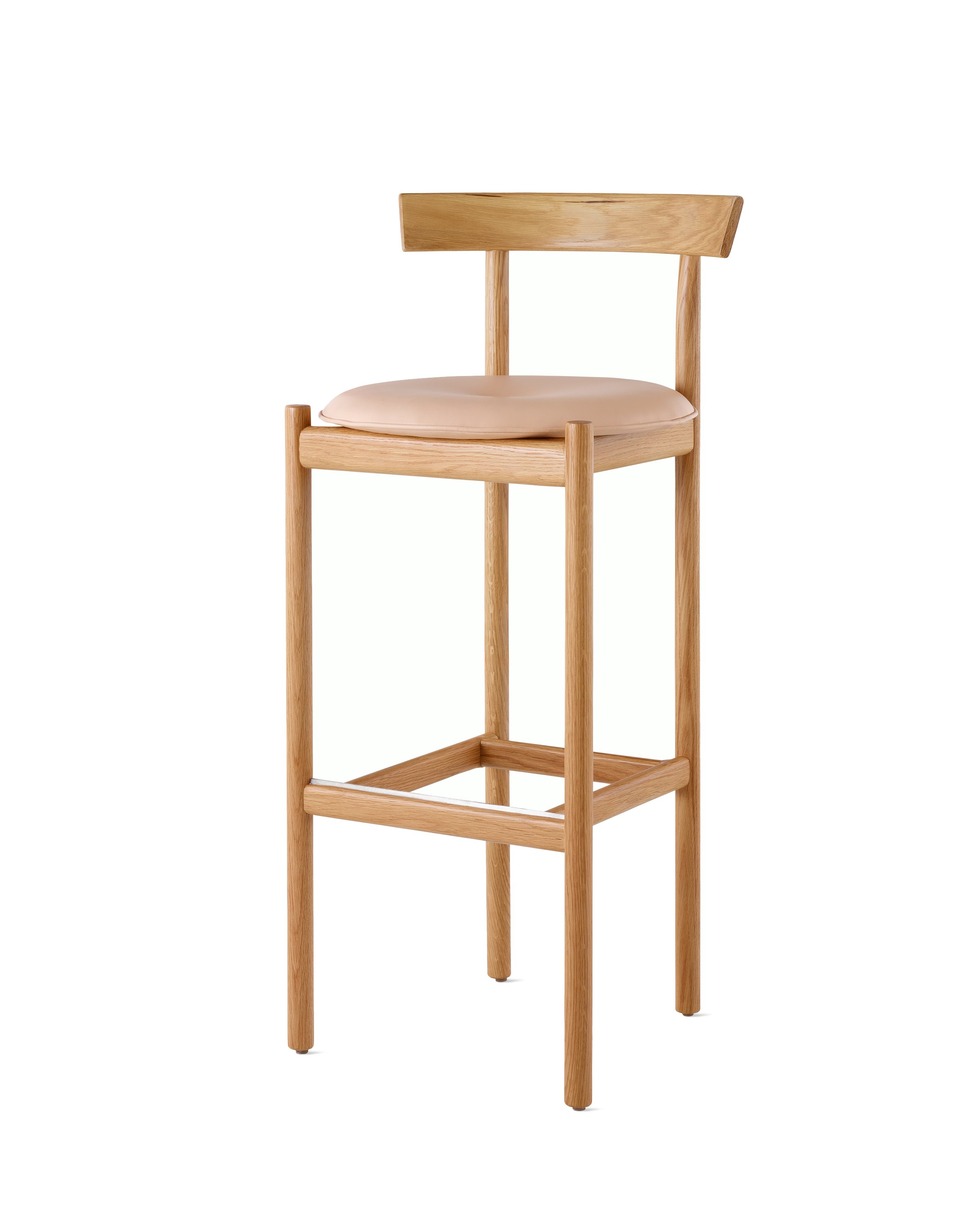 An oak bar-height Comma Stool with a seat pad, viewed from the front at an angle.