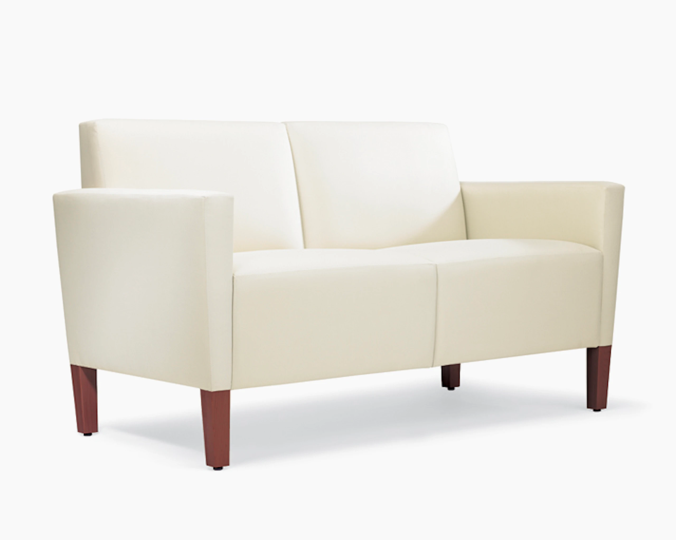 A three-quarter view of a Brava Classic Lounge Settee with white textile and upholstered arm caps.