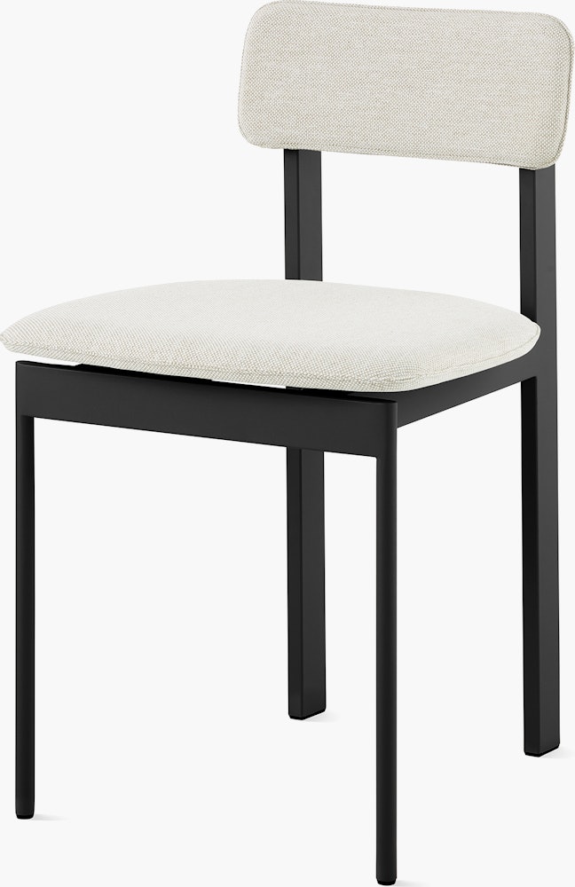 A Betwixt Chair with light grey fabric and a black frame.