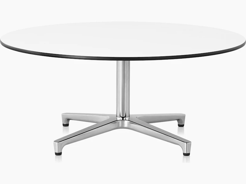 The upper portion of a round Saiba occasional table, showing the white back-painted glass top.