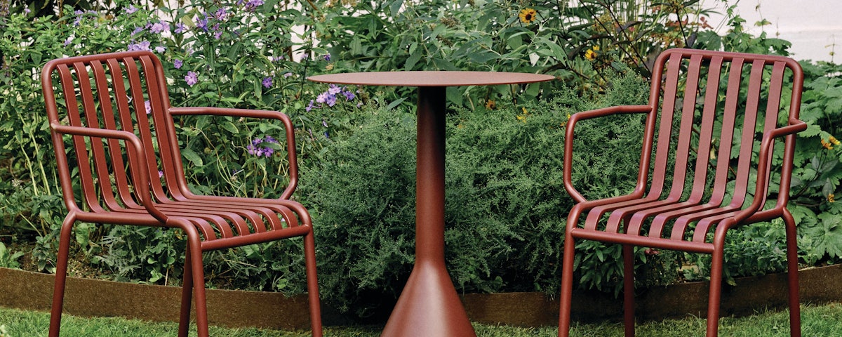 Palissade Armchairs and Palissade Cafe Table Cone Base in an outdoor setting