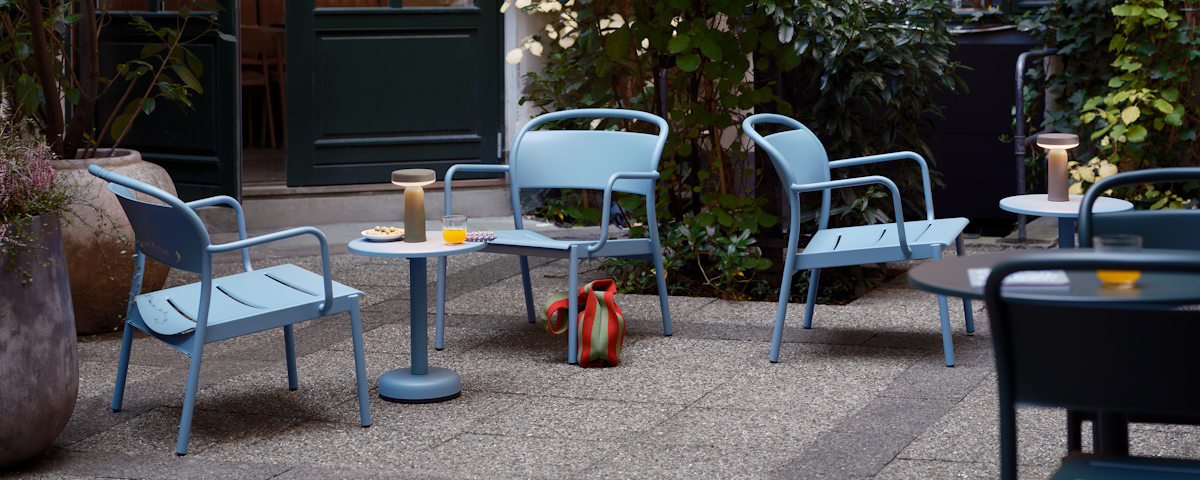 Linear Steel Lounge Chairs in Pale Blue in a cafe patio setting