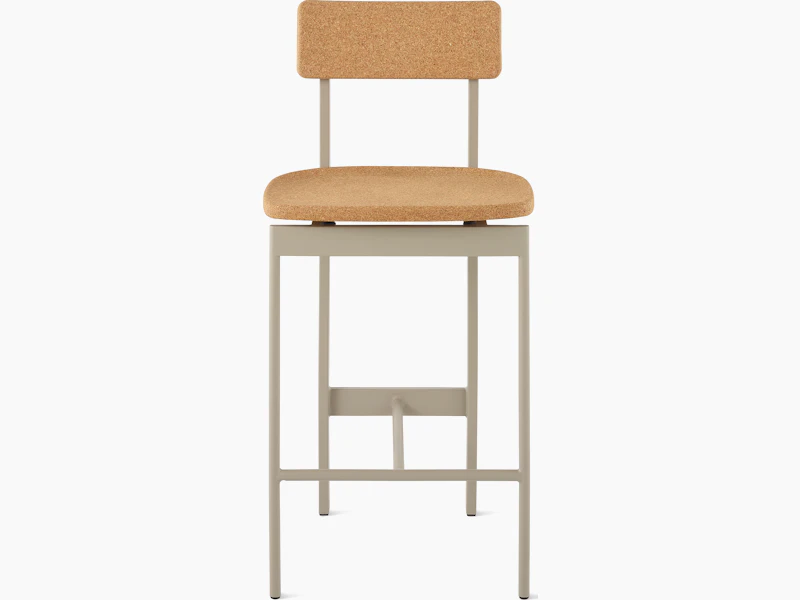 A counter height Betwixt Stool with cork seat and backrest, with a grey frame.