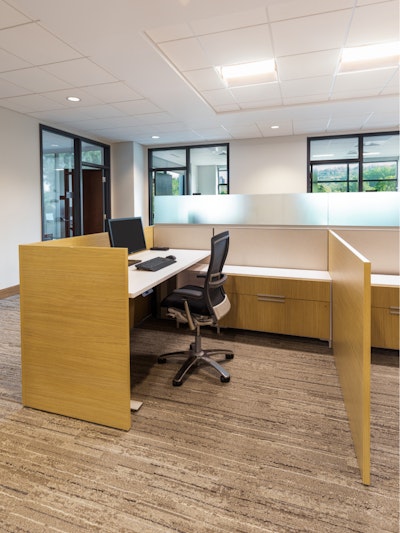 An individual workstation and computer featuring a Knoll Life Chair