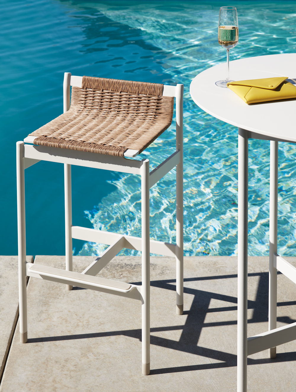 Sommer Barstool and Sommer Bar Table at a poolside setting