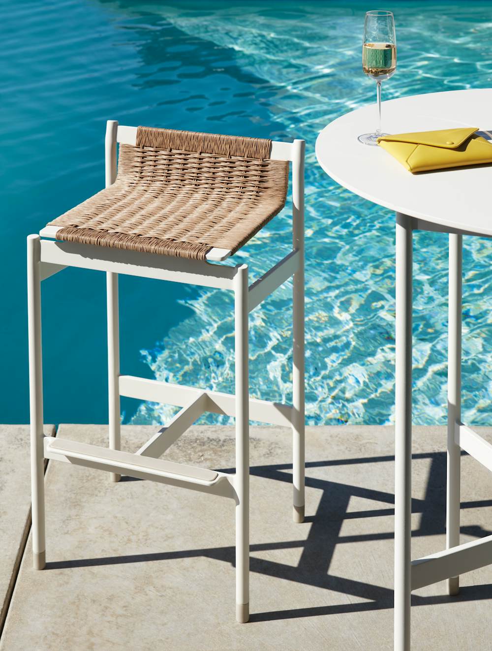 Sommer Barstool and Sommer Bar Table at a poolside setting