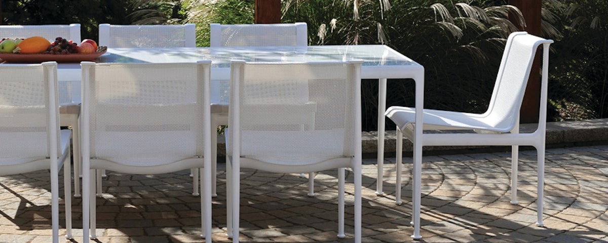 1966 Collection Porcelain Dining Table and 1966 Collection Dining Chairs in an outdoor dining setting