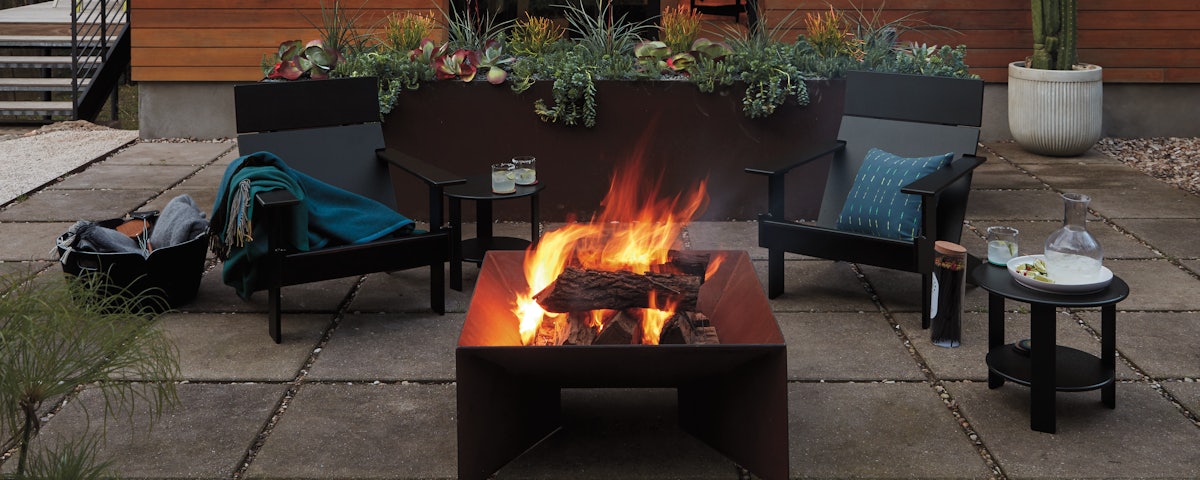 Lollygagger Chairs and Plodes Geometric Fire Pit in an outdoor patio setting