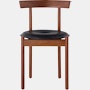 A walnut Comma Chair with a seat pad, viewed from the front.