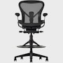 Black matte Aeron Stool on a white background, with a 5-star base and ergonomic back support, viewed from the front.