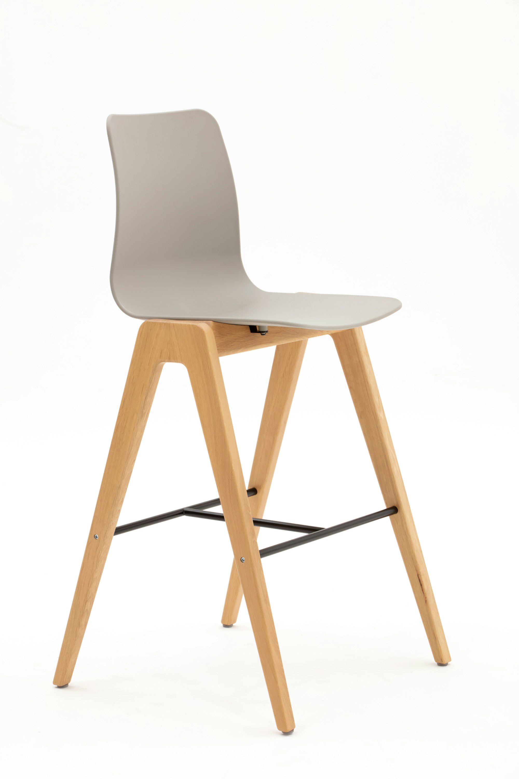 A tan Polly Wood Stool with oak base, viewed at an angle.