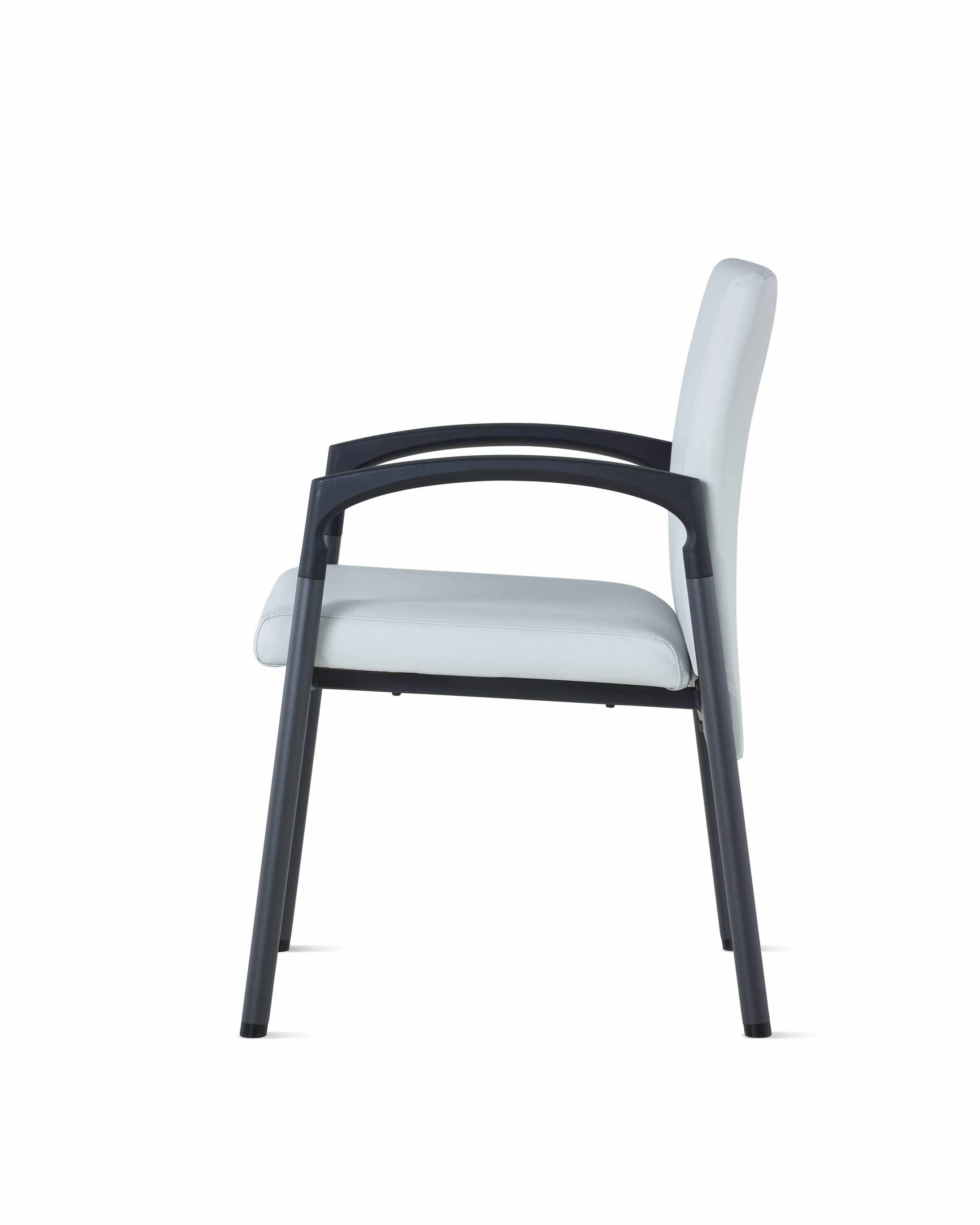 Side view of Valor Side Chair in a light gray upholstery on the back and seat and a black metal frame.