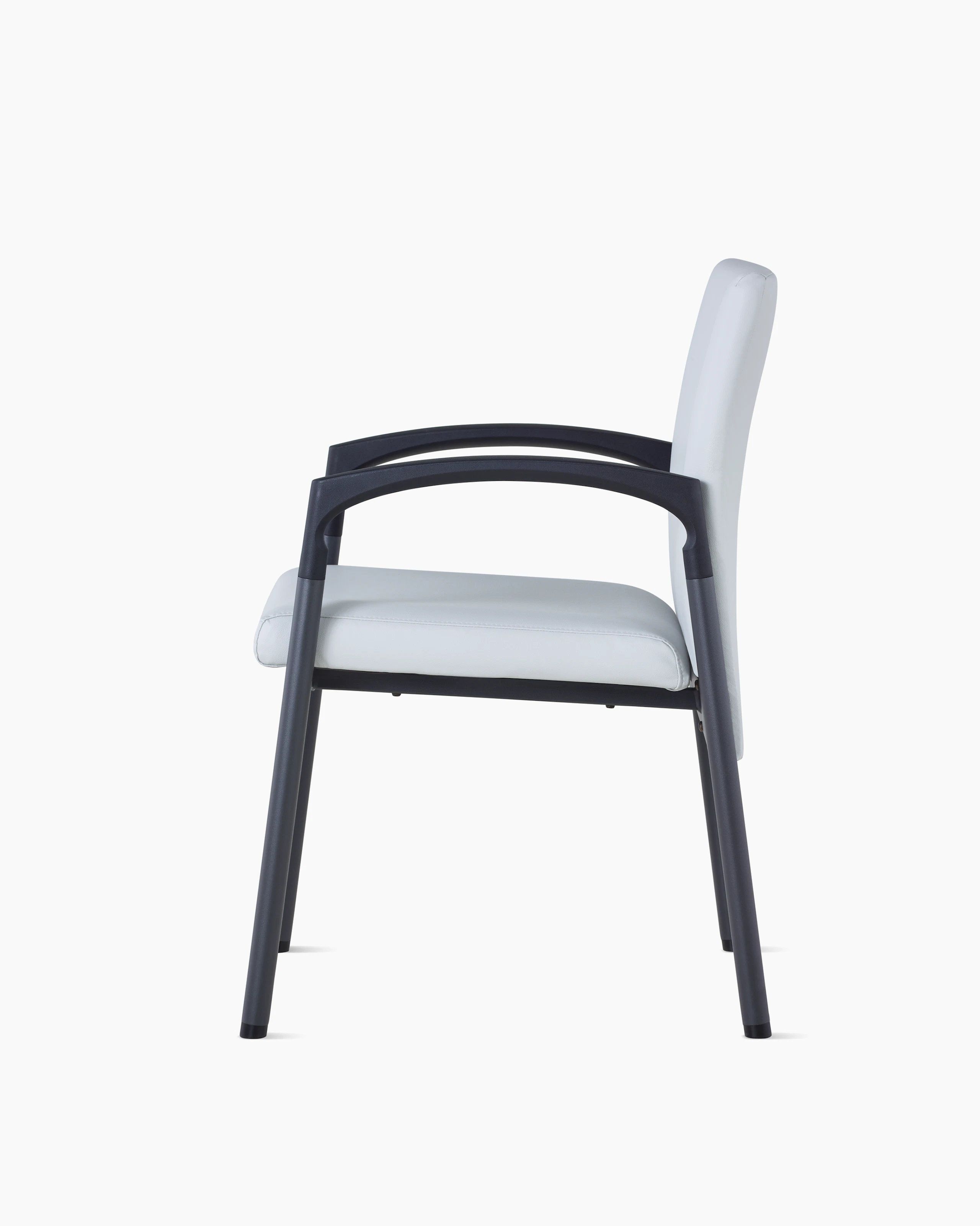 Side view of Valor Side Chair in a light gray upholstery on the back and seat and a black metal frame.