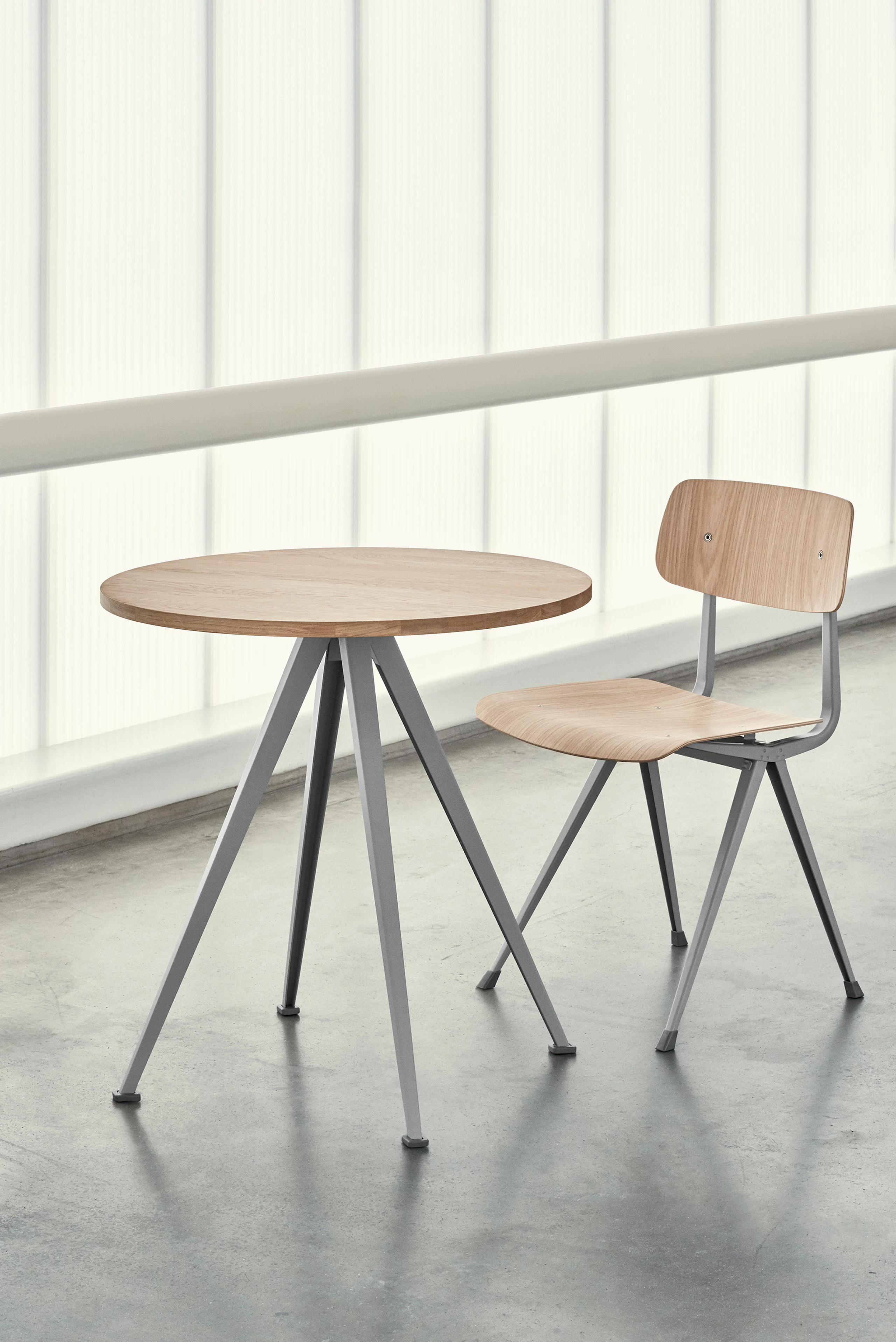 Pyramid Cafe Table with Oak top and beige frame next to a Result Chair.