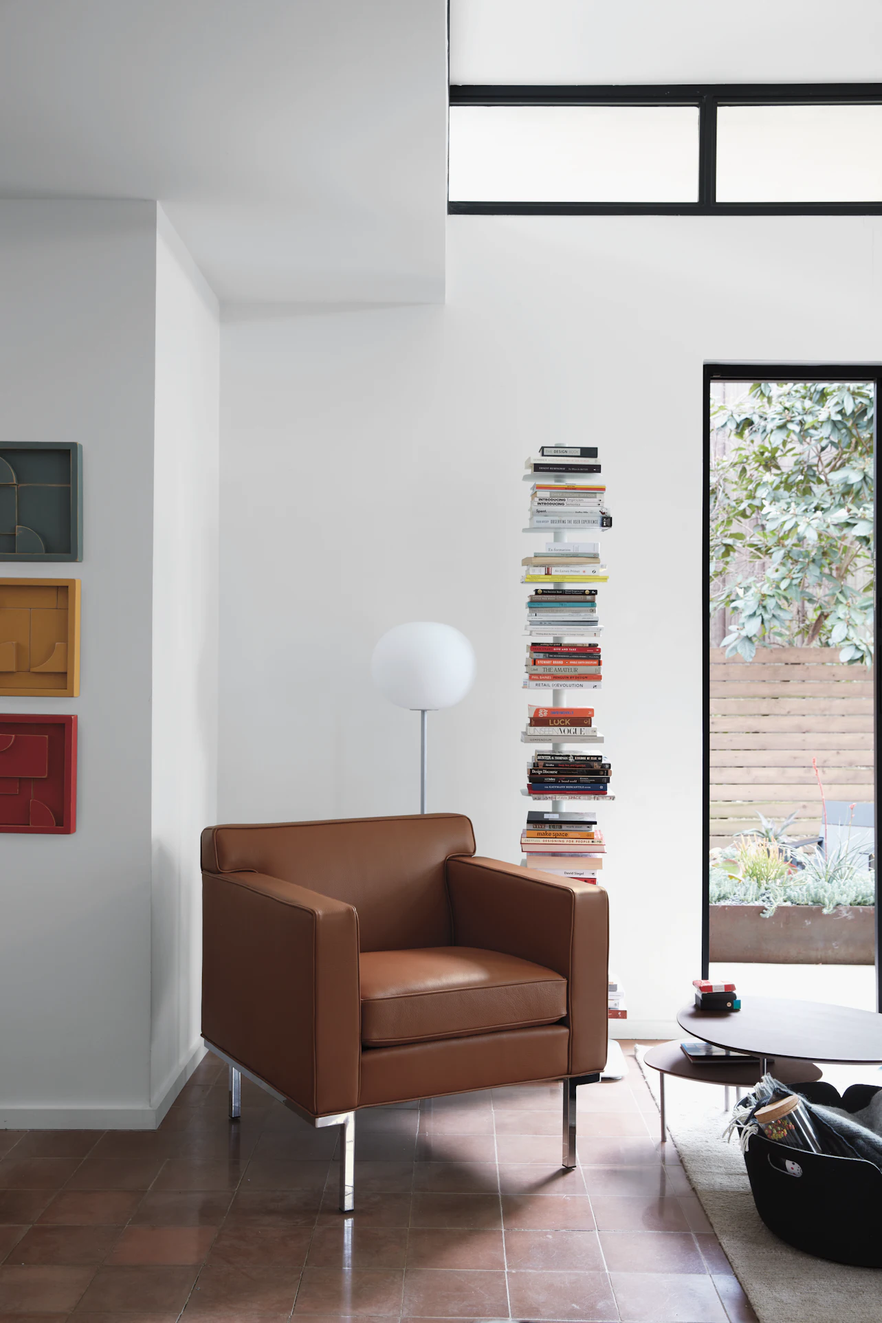 Brown leather theatre armchair with chrome legs in a contemporary setting.