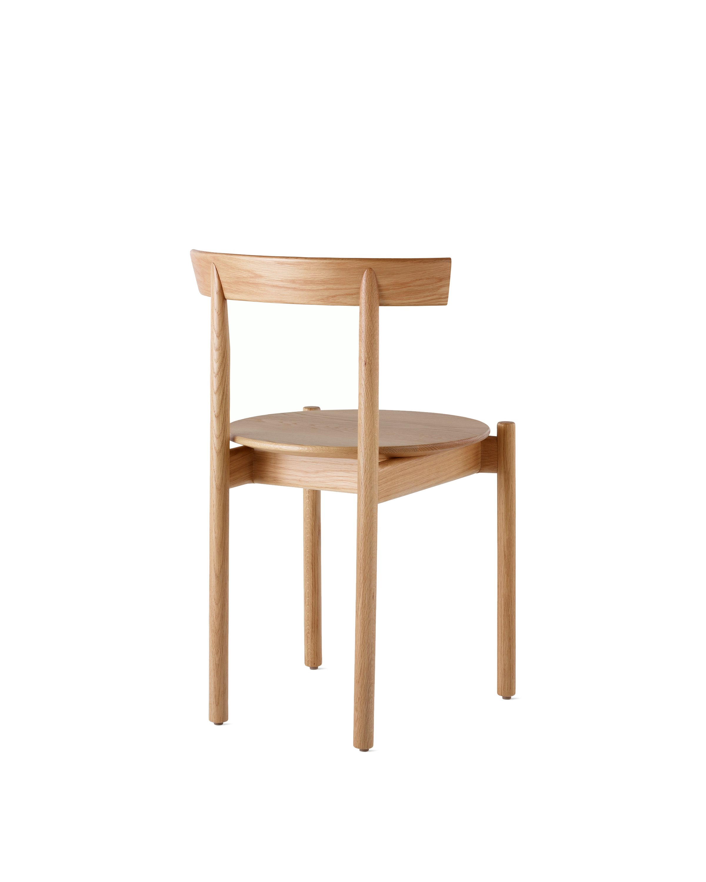 An oak Comma Chair, viewed from the back at an angle.