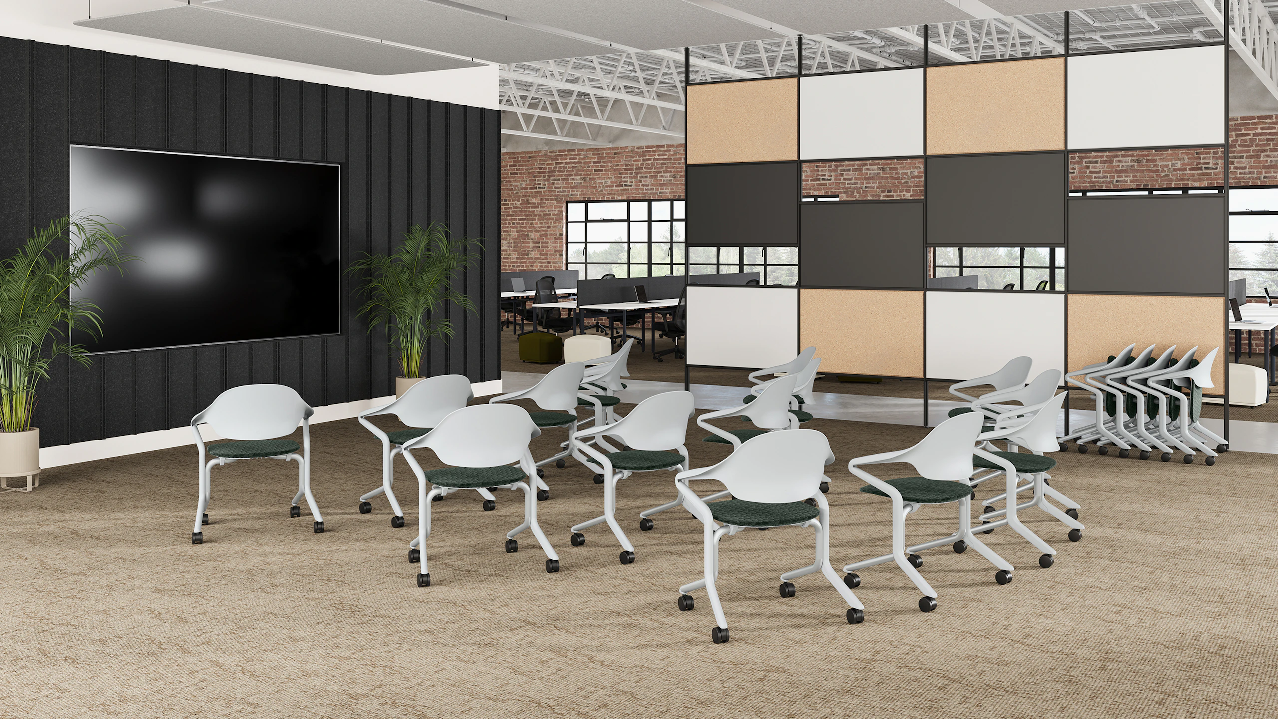 An training environment filled with alpine Fuld chairs , with a large monitor and bordered by a multicolor wall.