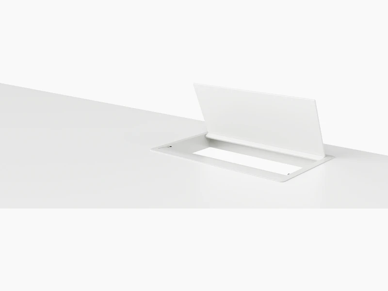 An open, white, desktop pop-up power port.